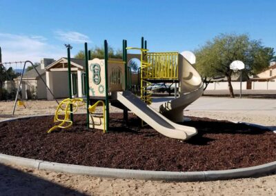 Commercial playground structure with multiple slides and climbers