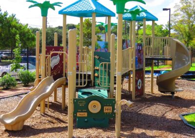 Large commercial playground with a spiral slide and climbing features