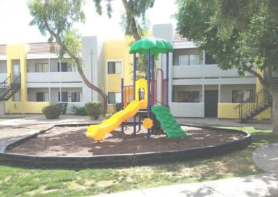 Colorful commercial playground with a themed canopy at an apartment community